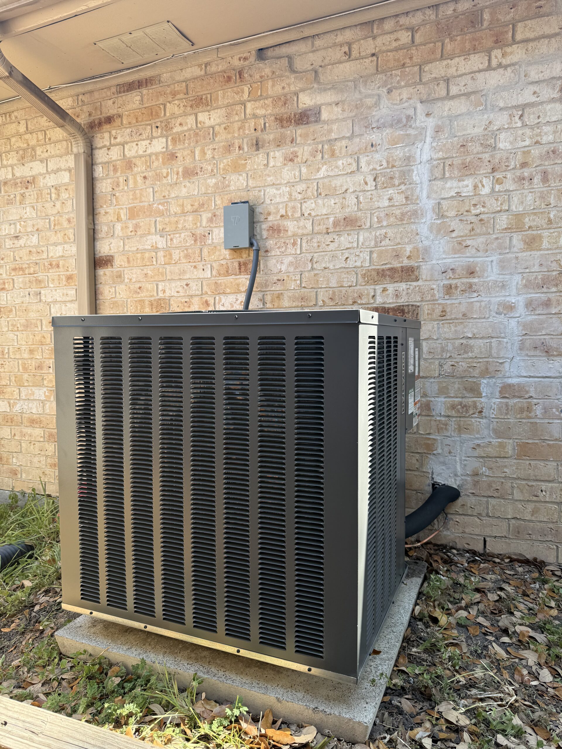 New outdoor AC condenser installation at a San Antonio home