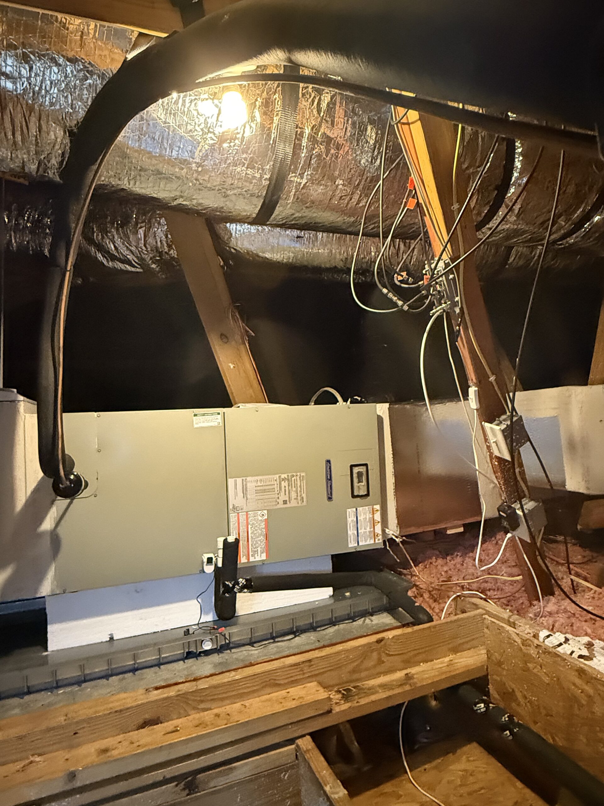 Inspecting evaporator coil inside air handler in San Antonio home